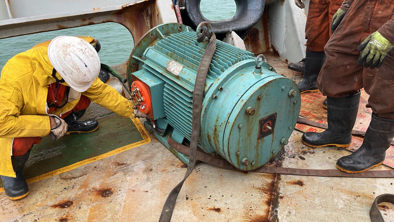 Technician servicing an industrial electric motor